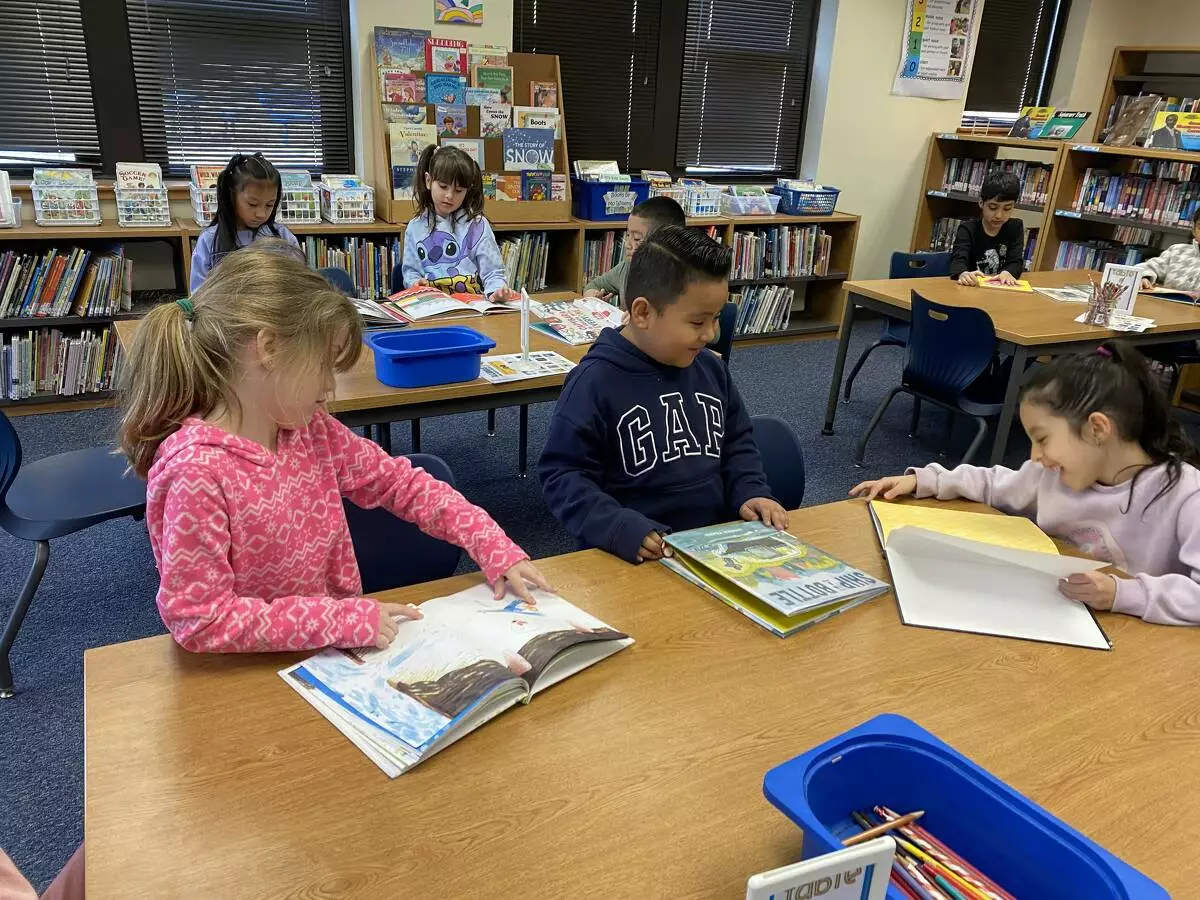 First graders decide which book to vote for.