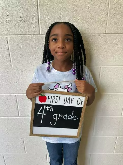 A fourth grader poses for a first day of school picture!