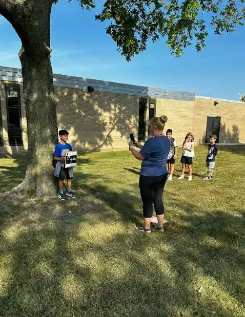 Mrs. Davey takes pictures of her students on their first day of school.