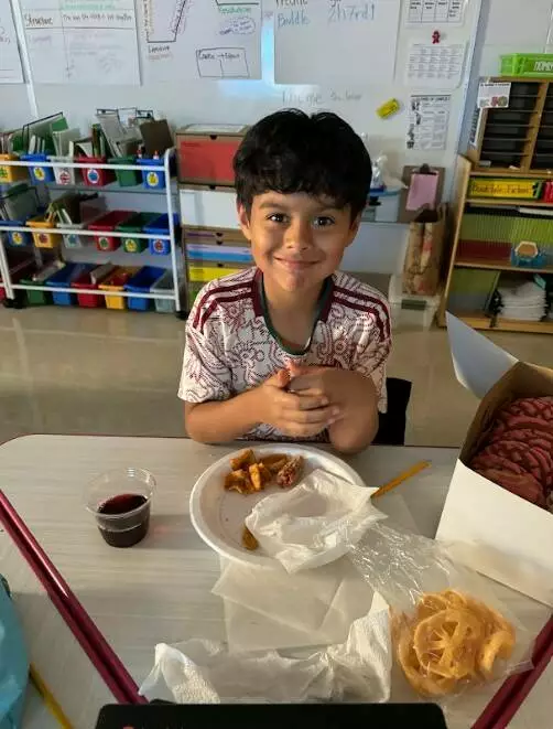 A fifth grader enjoys the Hispanic Heritage feast!