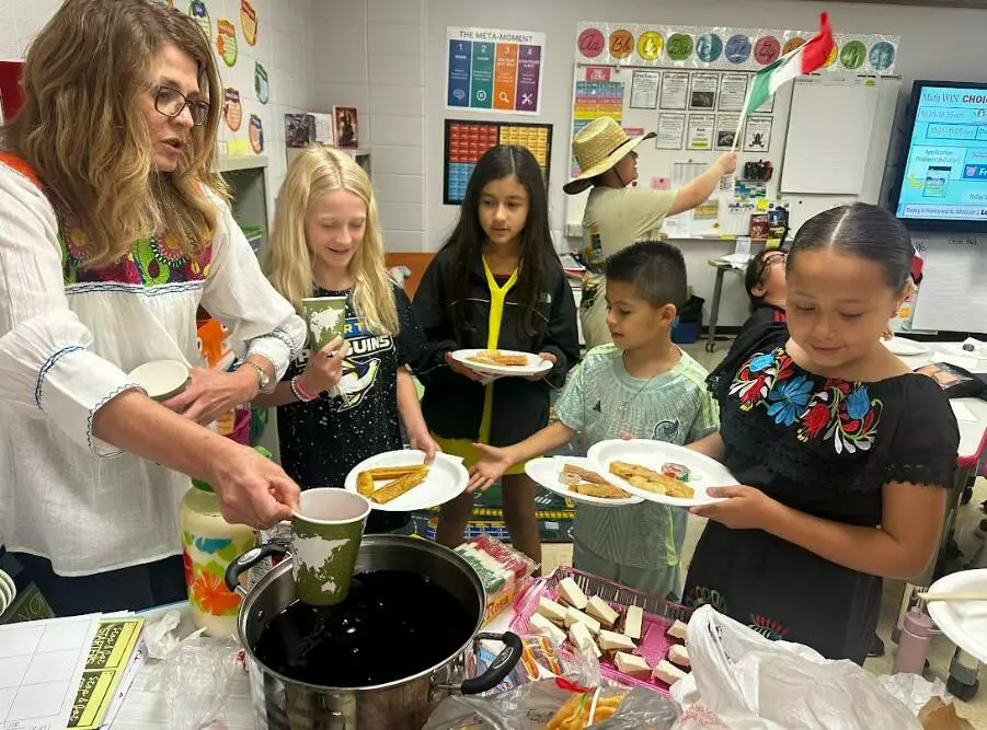 Mrs. Giovannelli serves her students freshly made hibiscus tea. 