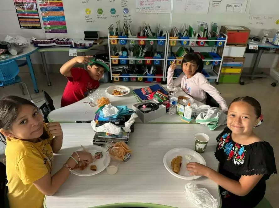 Fifth graders celebrate Hispanic Heritage Month with plates full of delicious food.