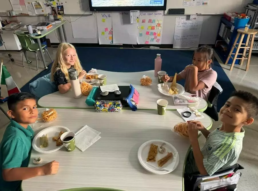 Fifth graders celebrate Hispanic Heritage Month with plates full of delicious food.