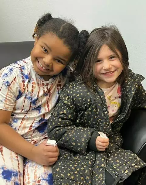 Two students celebrate together.