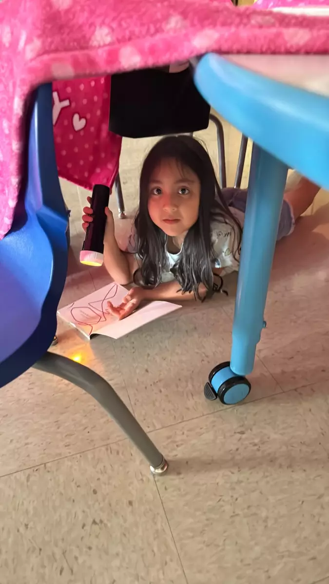 This first grader turned a desk and blanket into a cozy book nook.