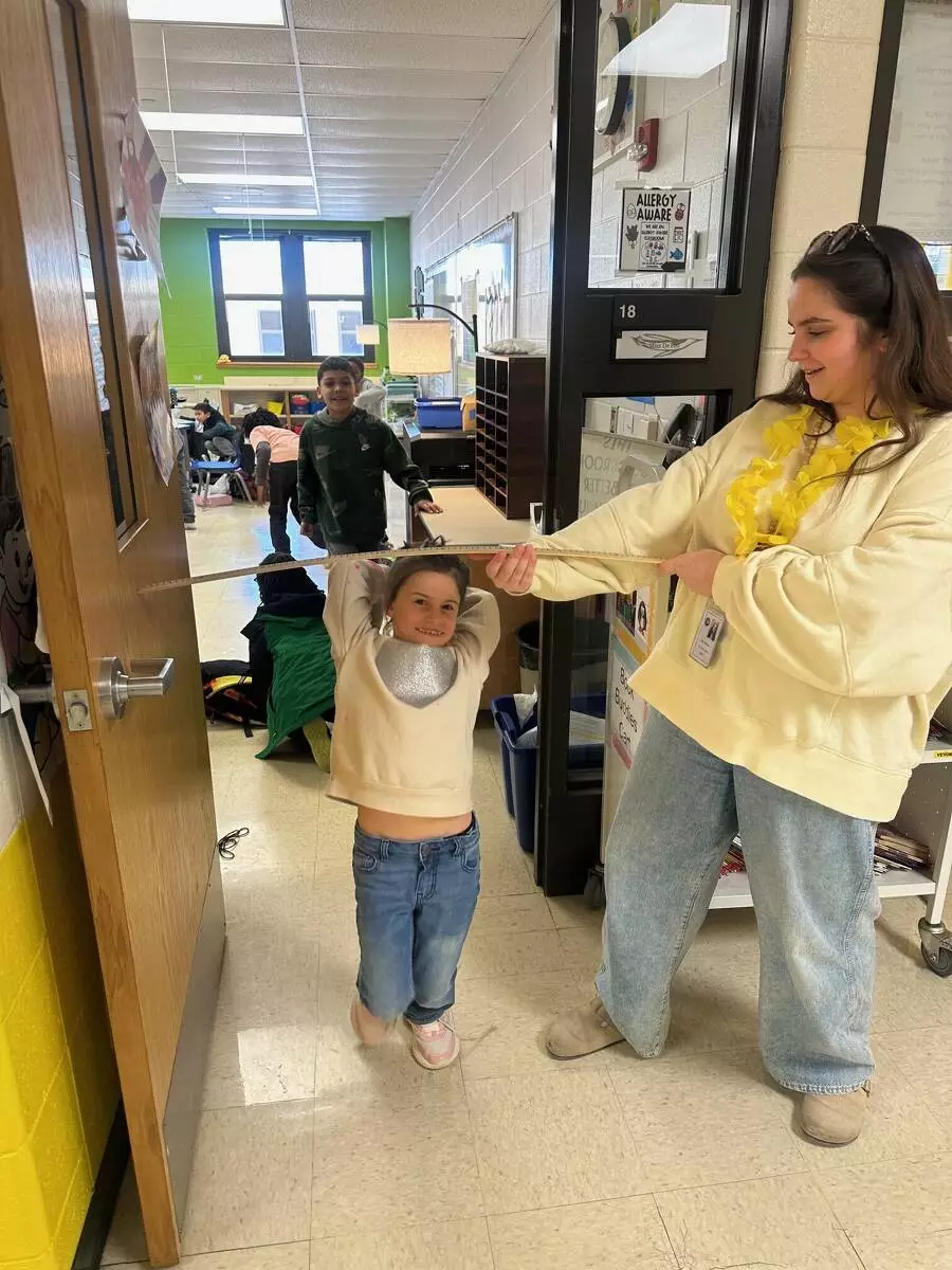 Teachers were creatively using yard sticks as extra limbo poles. 