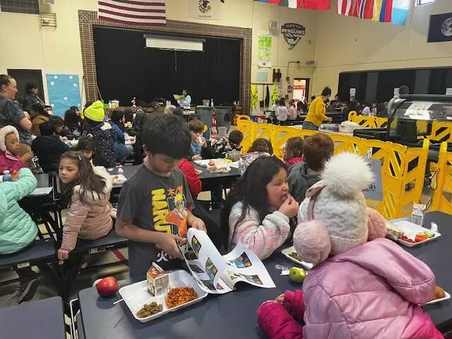 First graders eat lunch and follow along with the books Mrs. Carpenter is reading. 