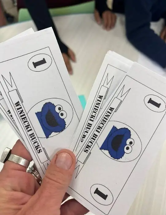 Students used classroom currency to purchase products from their peers. 